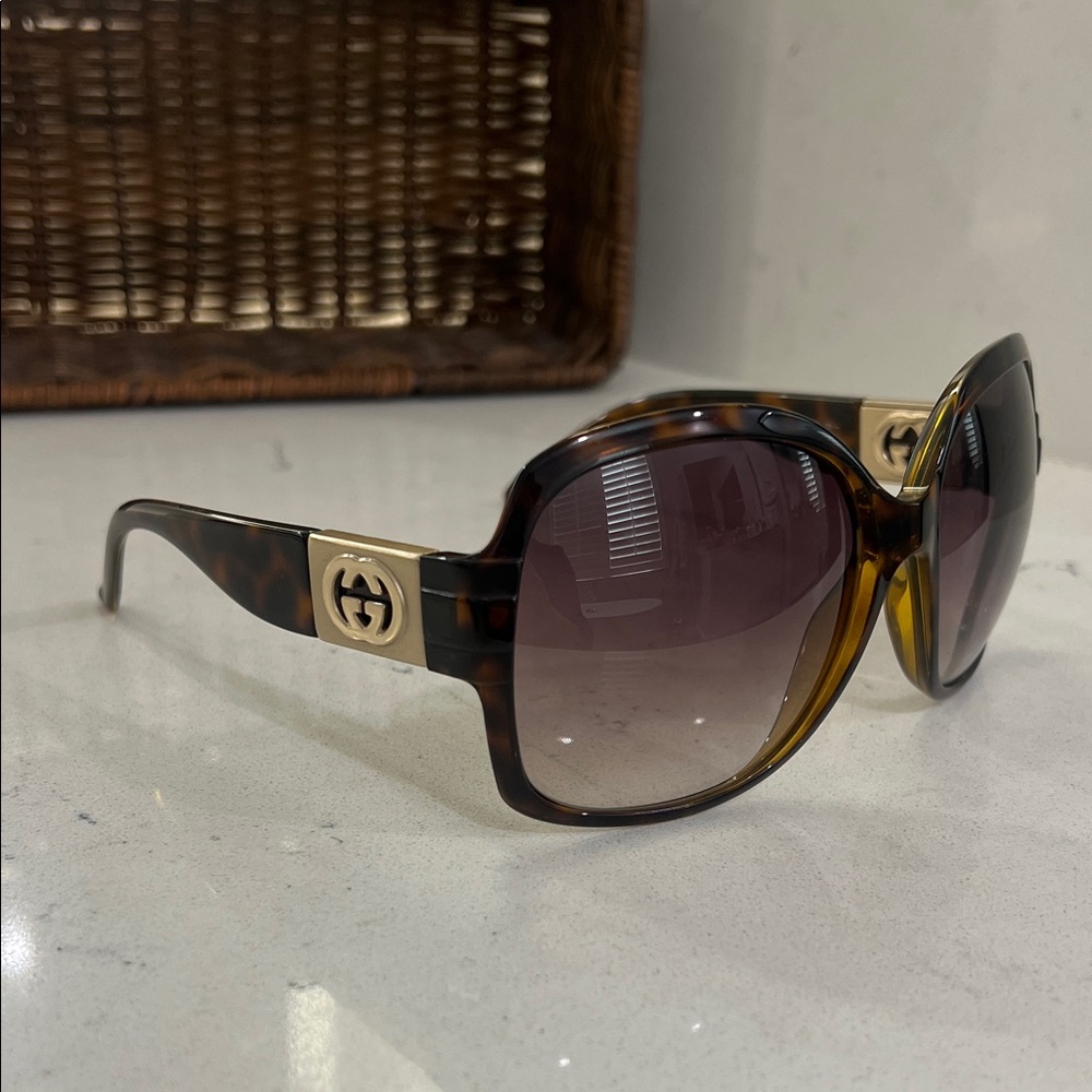 Gucci Brown Tortoise Sunglasses with Gold Accents.